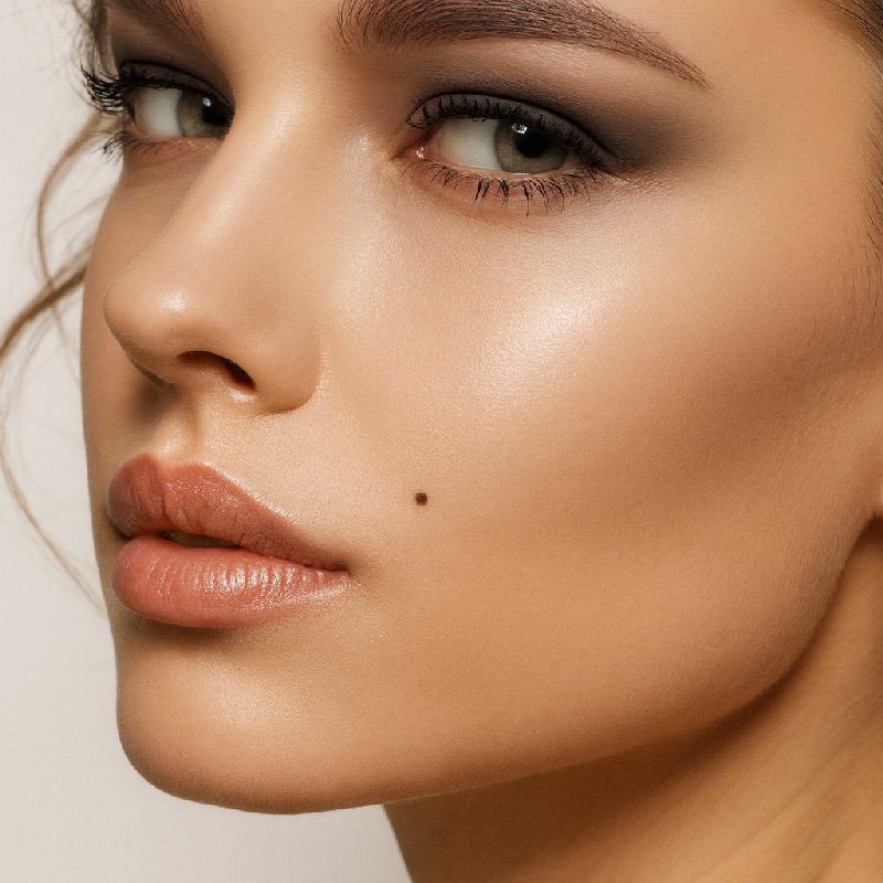 她脸颊上有一个小痣，增添了她的魅力。