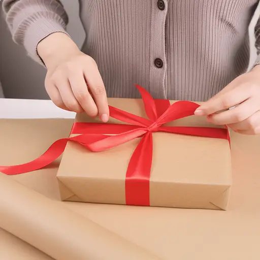 她将礼物用纸包起来并用蝴蝶结系好。