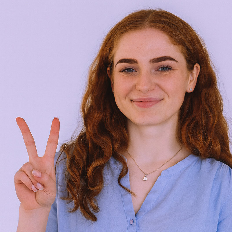 她用食指和中指做了一个V字手势。